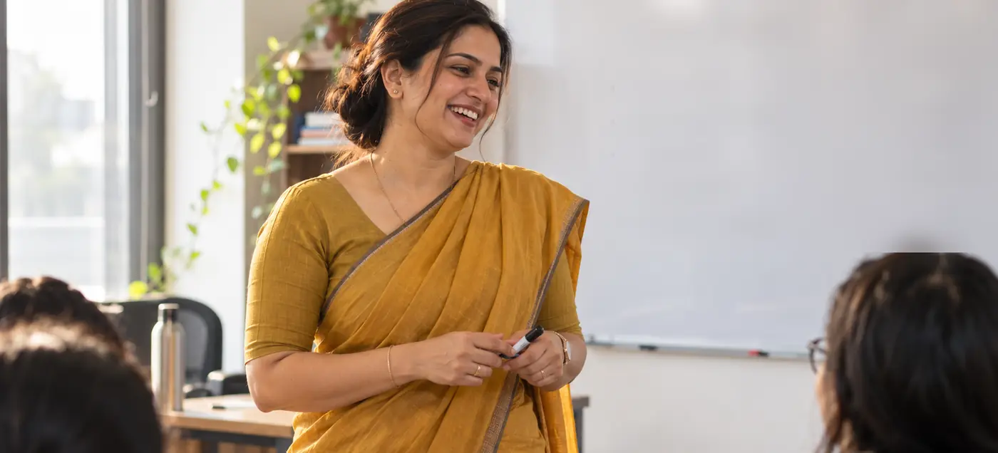 Teacher smiling with her class at a coaching institute